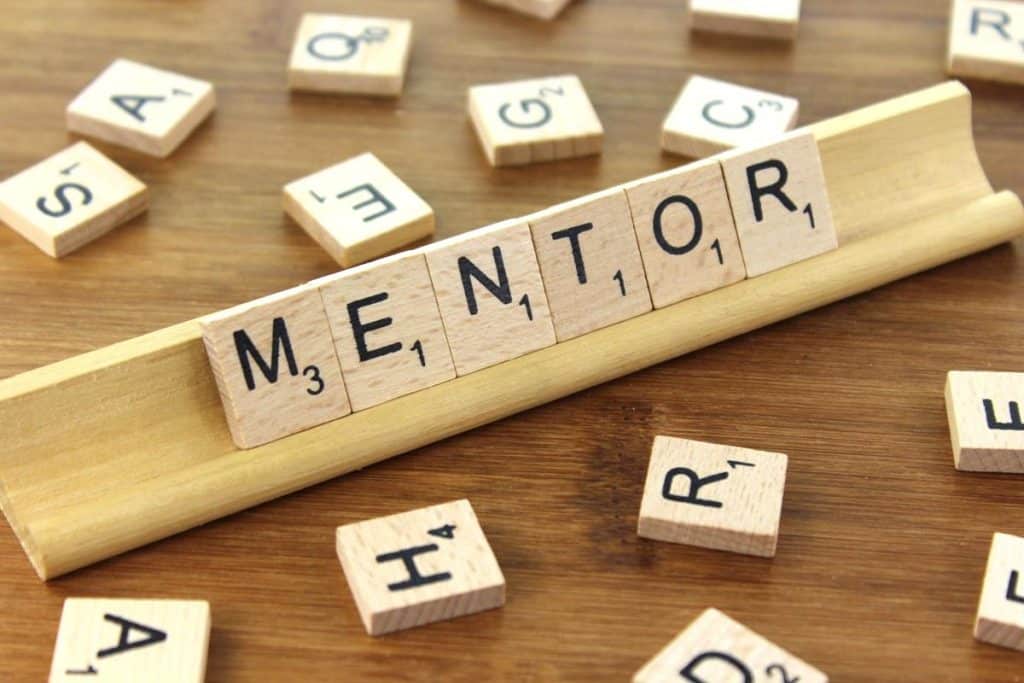 Scrabble tiles with the word "MENTOR"